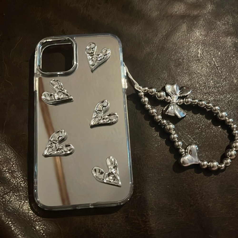This is an iPhone 11 mirror case with hearts